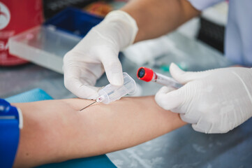 Close up hand of nurse, taking blood sample from a patient in the hospital.	