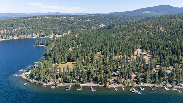 Aerial view captured by drone of the deep blue water at lake coeur d'alene in Harrison, Idaho. The water is calm and is a popular tourist destination for water sports. 