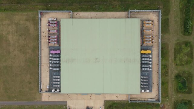 Top down aerial drone view of large data center in England, UK futuristic cutting edge technology with cooling fans and quantum computing data storage.