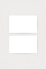 Fototapeta premium Two blank white business cards mockup on a textured light gray background