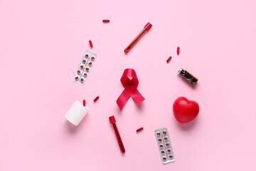 Red ribbon with pills, test tubes and heart on pink background. Blood Cancer Awareness Month