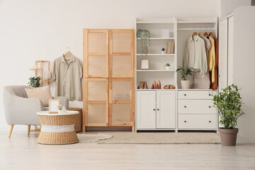 Interior of dressing room with closet, armchair and table