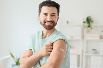 Young man with applied medical patch after vaccination in clinic