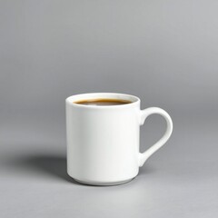 A simple white mug filled with dark coffee on a gray background