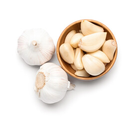 Wooden bowl with fresh garlic cloves on white background