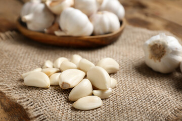 Fresh garlic cloves on wooden background, closeup