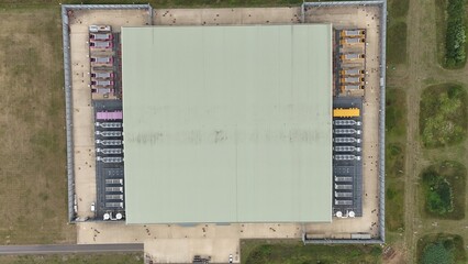 Aerial top down view of large futuristic cutting edge technology data center in England, with cooling fans and turbines, quantum computing and data storage.
