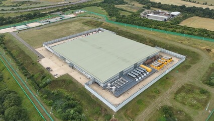 Aerial Drone Footage of Futuristic Data Center and Quantum Computing Facility in Rural England, cooling fans and quantum computing.