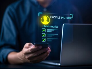 Person holding smartphone viewing digital profile with check marks and laptop in background mobile