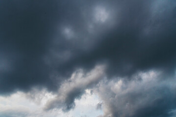 Dramatic dark storm thundercloud rain clouds on black sky background. Dark thunderstorm clouds...