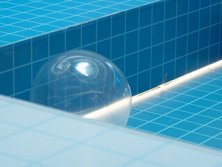 Balloons on the background of a blue mosaic swimming pool without water