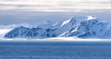 Mountainous ice and snow landscapes on the departure from Longyearbyen, Isfjorden Fjord, Svalbard, Norway