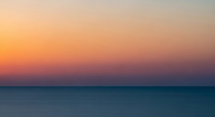 Fototapeta premium Serene Sunset over Calm Ocean: Abstract Coastal Landscape Photography