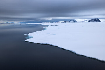 Floating ice on the ocean with cloud reflection in the arctic of Svalbard, Norway
