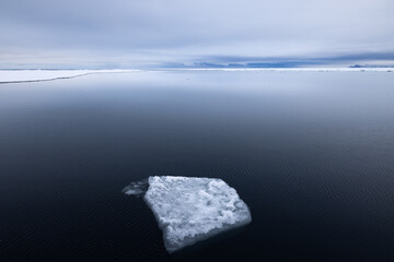 Floating ice on the ocean with cloud reflection in the arctic of Svalbard, Norway  © Reto Ammann