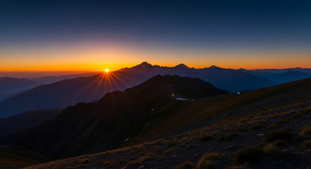 Golden Sunburst Over Rugged Mountain Peaks at Dawn