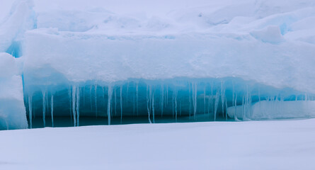 Icicle and blue light reflections in the arctic ice north of Svalbard, Norway © Reto Ammann