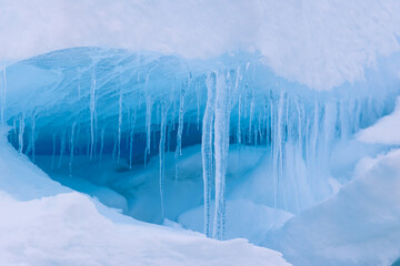Icicle and blue light reflections in the arctic ice north of Svalbard, Norway © Reto Ammann