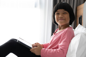 Joy childhood bright playful portrait happy child digital screen learning fun app education entertainment cozy creative children play modern family at home.