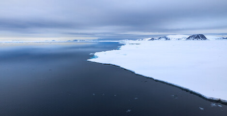 Floating ice on the ocean with cloud reflection in the arctic of Svalbard, Norway
