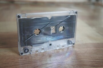 Retro audio cassette isolated on wooden table background, pop art design, close-up