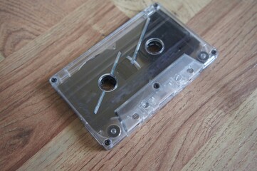 Retro audio cassette isolated on wooden table background, pop art design, close-up