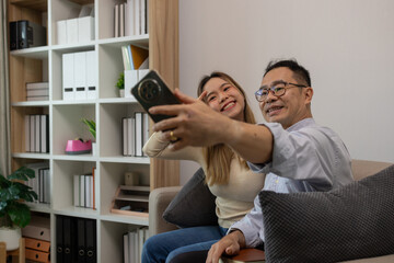 a father and daughter are spending their free time together at home, the daughter spends her weekend visiting her elderly father, a family full of love between a father and daughter