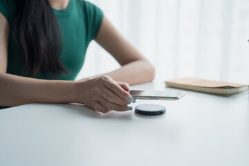 Fototapeta premium Charging mobile phone battery with wireless charging device in the table. Smartphone charging on a charging pad. Mobile phone near wireless charger Modern lifestyle technology.