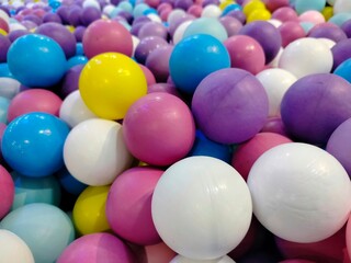 Top view image of a vibrant and colorful plastic ball background in various colors.