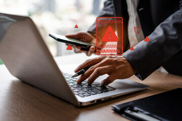 Businessman using computer laptop with caution warning sing for notification error and virus detection spyware, Internet network security concept