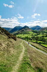 Fototapeta premium The Newlands valley in the Lake District National Park, Cumbria. SW over walkers paths to fells of Hindscarth and Robinson. Spring colours