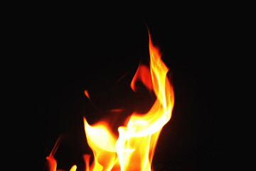 Close up burning flames on black background for graphic design or wallpaper.