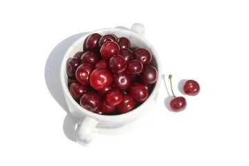 There is a pile of ripe juicy cherries on the plate.	