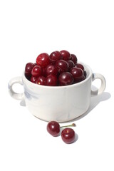 There is a pile of ripe juicy cherries on the plate.