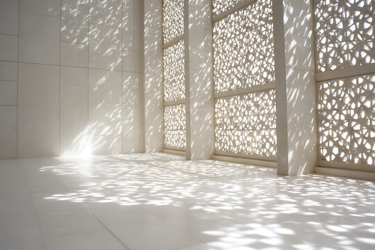 Sunlight streaming through intricate geometric patterned windows creating dappled light and shadow patterns on a clean white interior floor and walls