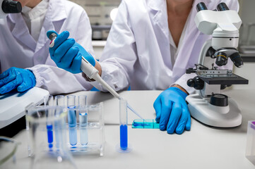 Unknown lab technician working with lab pipette in medical laboratory