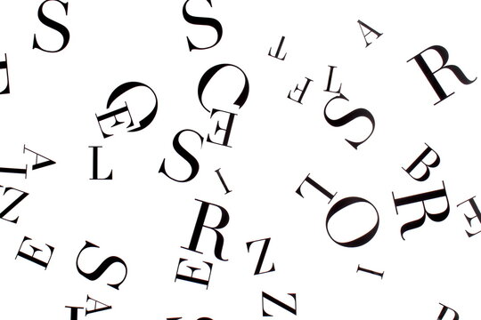 On a white background are English letters cut out of paper.