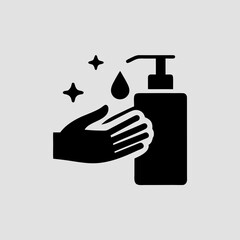 Black hand sanitizer bottle dispensing liquid onto open palm drop