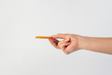Heart shaped sugared crackers in hand on white background