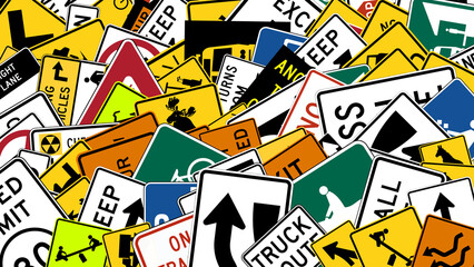 road signs arranged randomly with US law codings at various angles and sizes