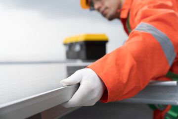 Solar panel. Rooftop solar power. Hand of engineer or technician inspecting installation quality of solar power systems on rooftop of building