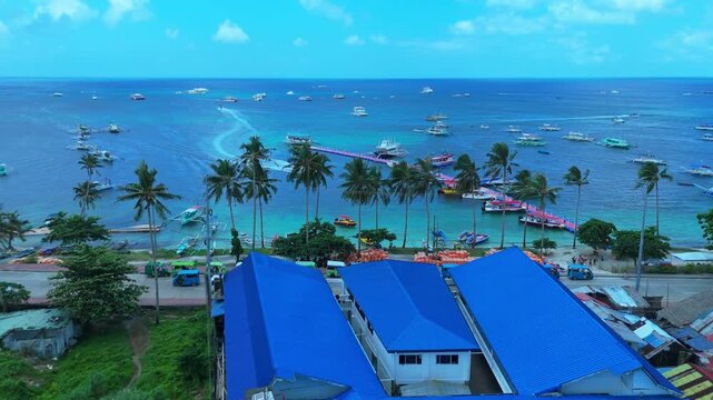 Stunning 4K aerial shot of Boracay's vibrant harbor with boats, palm trees, and turquoise waters—perfect for travel, tourism, and tropical lifestyle content.