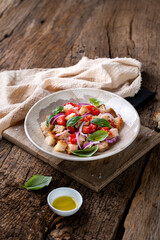 Fresh Italian Panzanella Salad with Tomatoes, Bread and Basil on Rustic Wooden Table