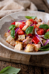 Fresh Italian Panzanella Salad with Tomatoes, Bread and Basil on Rustic Wooden Table