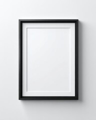 Black framed, blank canvas on a white wall