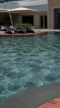 Young girl swimming in the pool and Fabulous view of the swimming pool at Okada Manila, one of the largest casinos in the Philippines