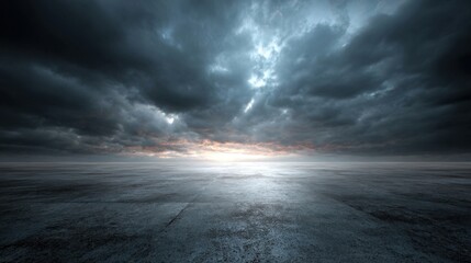 A stunning view features dark, ominous clouds hanging low in the sky above a vast, empty expanse. The fading light creates a striking contrast against the gloomy atmosphere.