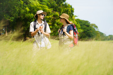 Man and woman are enjoy seeing a beautiful landscape and lake view while hiking.