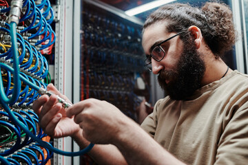 Concentrated IT expert connecting cables in data center