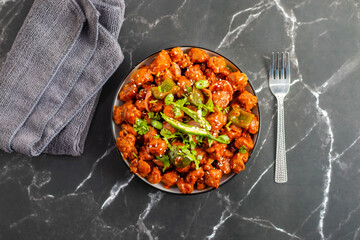 Soya Manchurian is a flavorful Indo-Chinese dish made with soya chunks tossed in spicy, tangy sauce, garnished with spring onions and bell peppers.
